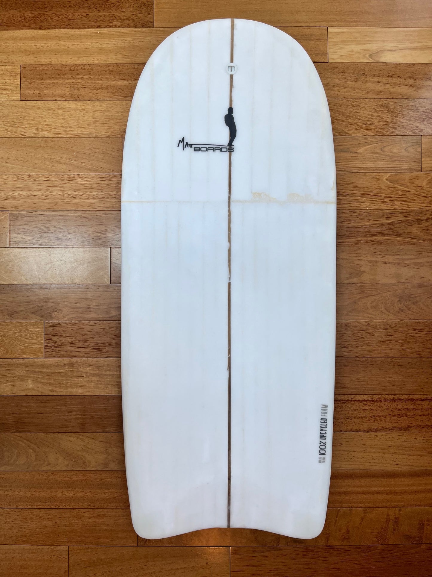 White body board with a black Matt Boards logo on a wooden background