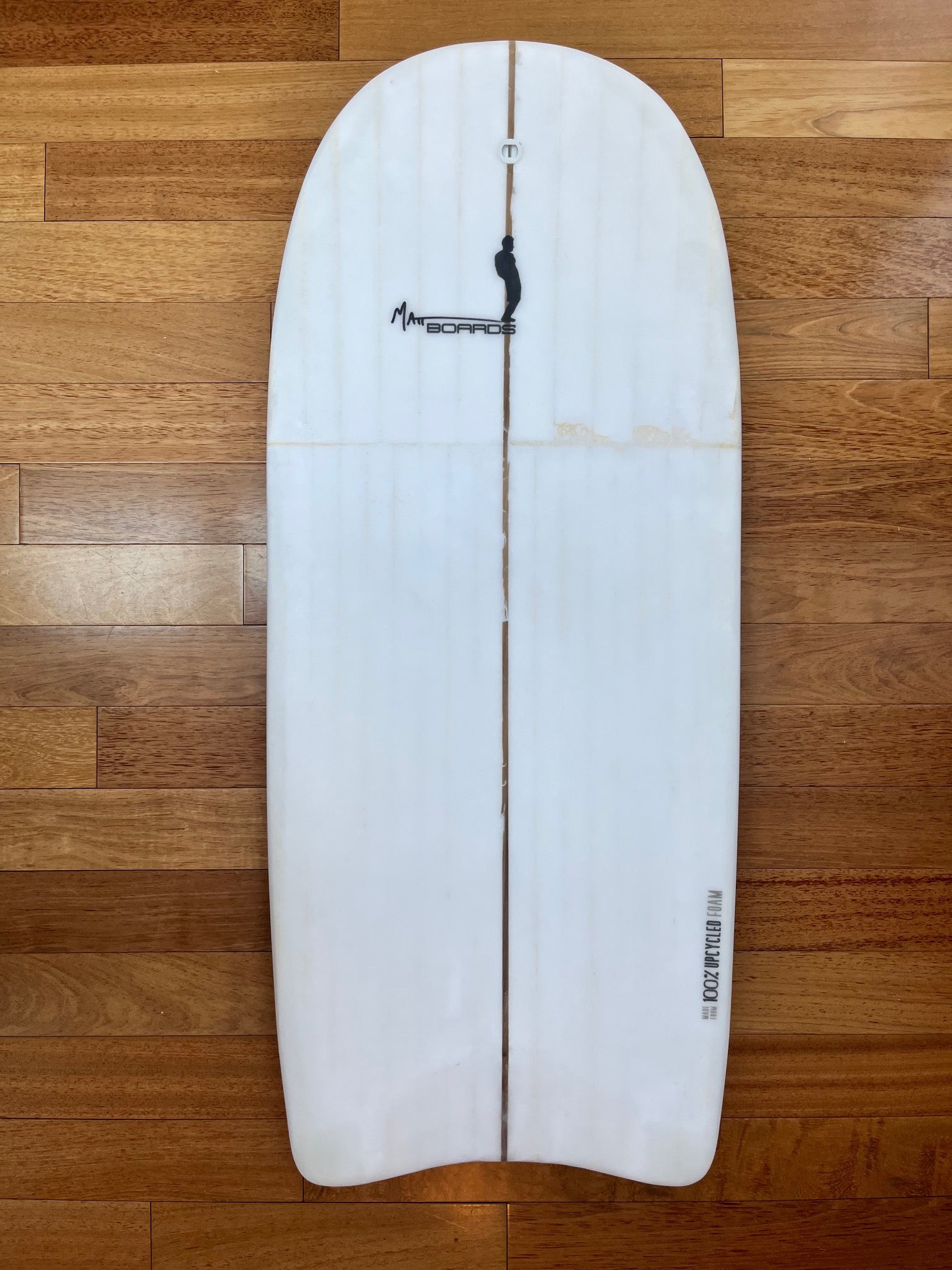 White body board with a black Matt Boards logo on a wooden background