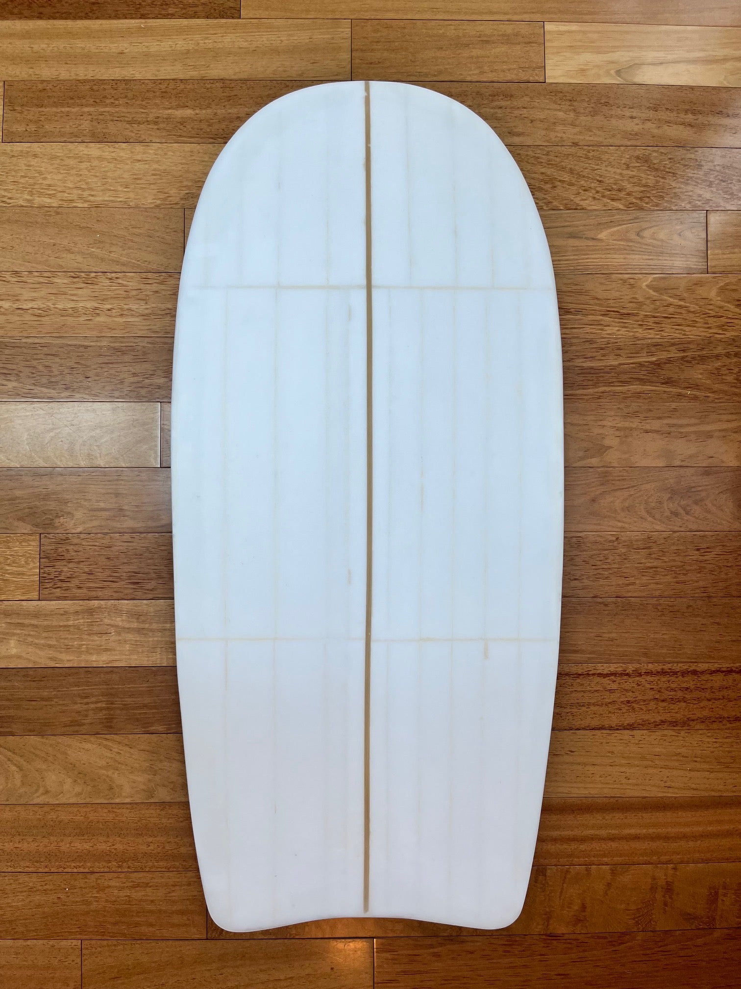 White body board on a wooden background